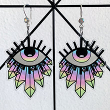 Load image into Gallery viewer, Large earrings featuring a stylized eye looking up, with blue, prurple, pink, yellow and green gradient see through iris and illustrated crystals at the bottom. With a silver hook with a multicolored rhinestone.

